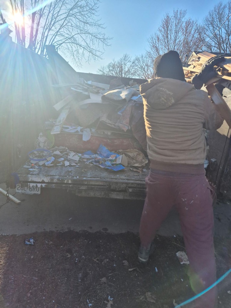 Heavy lumber loading into dump trailer